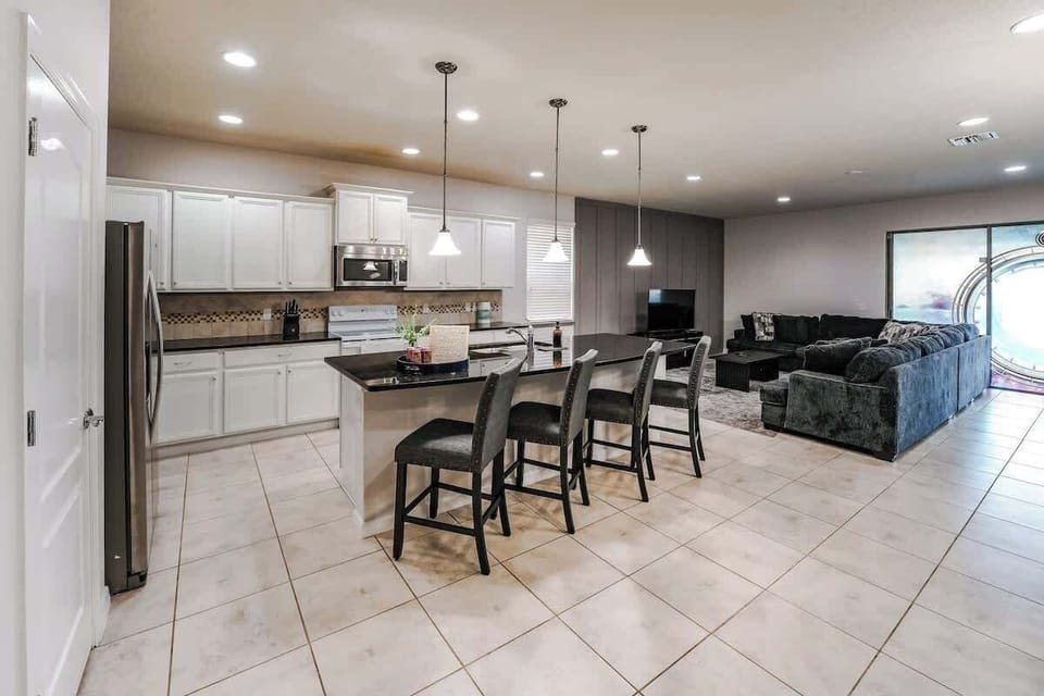 Enjoy seamless flow between the modern kitchen, island seating, and comfortable living area