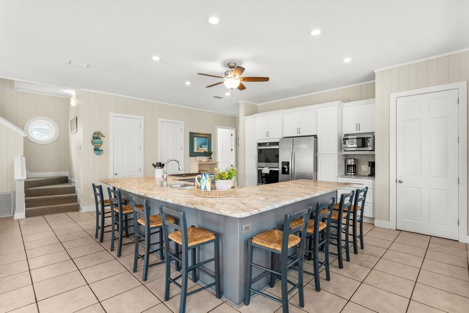 Large open kitchen with double oven, gas cooktop and stainless steel appliances 