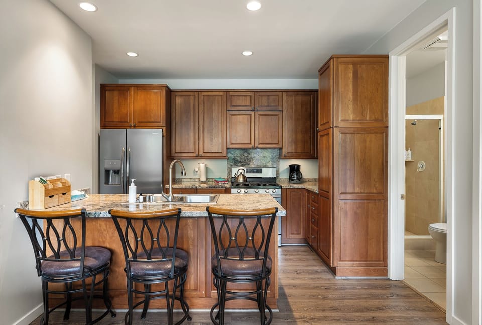 Fully stocked kitchen with a breakfast bar and seating to watch the magic happen