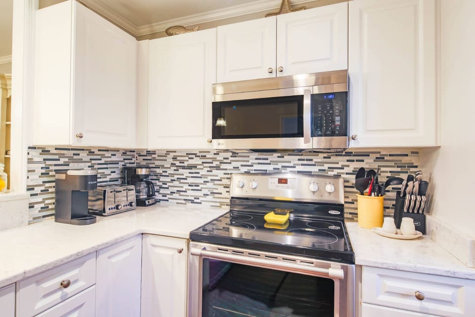 There is also a tiled backsplash, drip coffee maker and keurig in the kitchen.