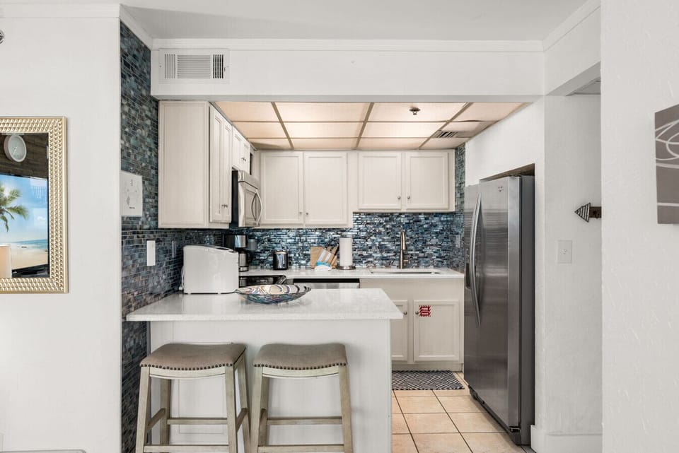 Coastal kitchen with modern finishes, bar seating, and everything you need to cook and unwind