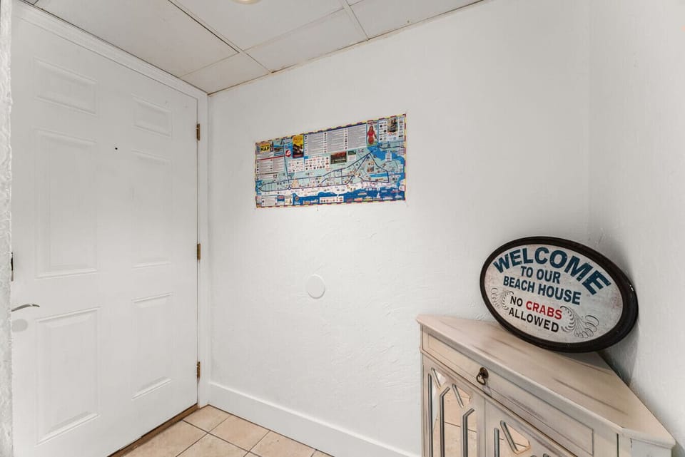 Charming coastal entryway with a playful ‘Welcome to Our Beach House’ touch.