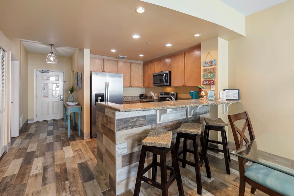Your fully equipped kitchen features granite counters, stainless appliances, and a breakfast bar where you'll start each morning with coffee.