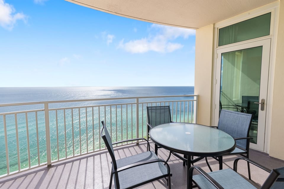 Sip your morning coffee while watching waves sparkle below from your private oceanfront balcony with comfortable seating.