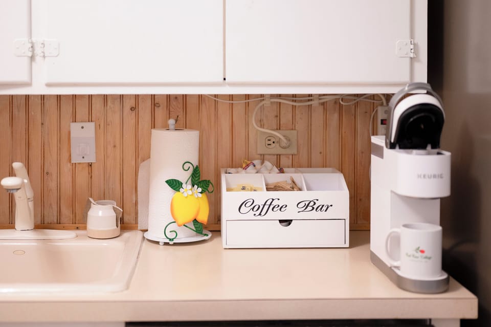 Keurig coffee machine with K cups and sugar and creamer provided (& to-go cups)