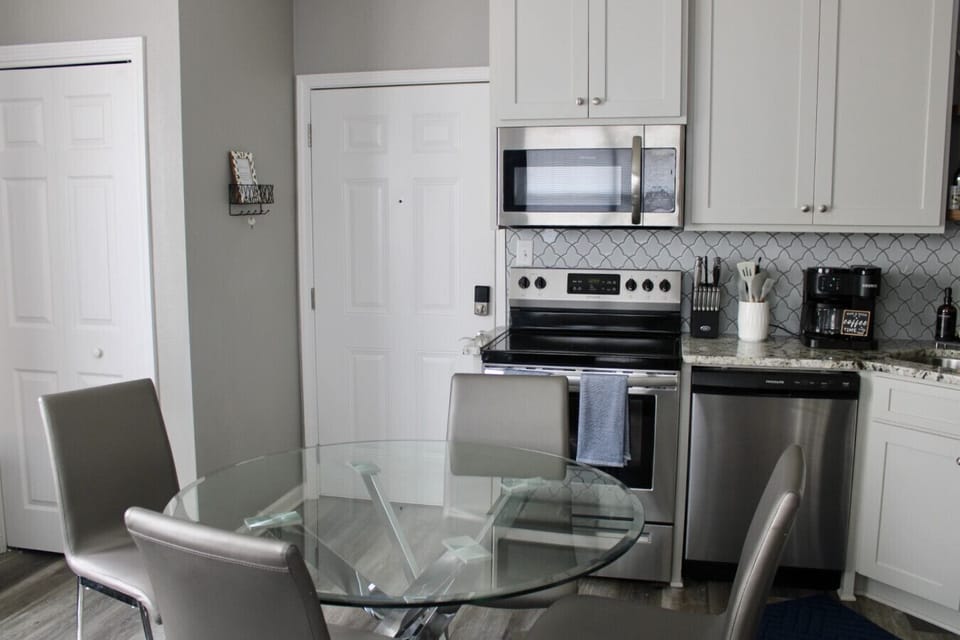 Dining Area: Sleek glass table invites shared meals in a stylish, modern kitchen setting!