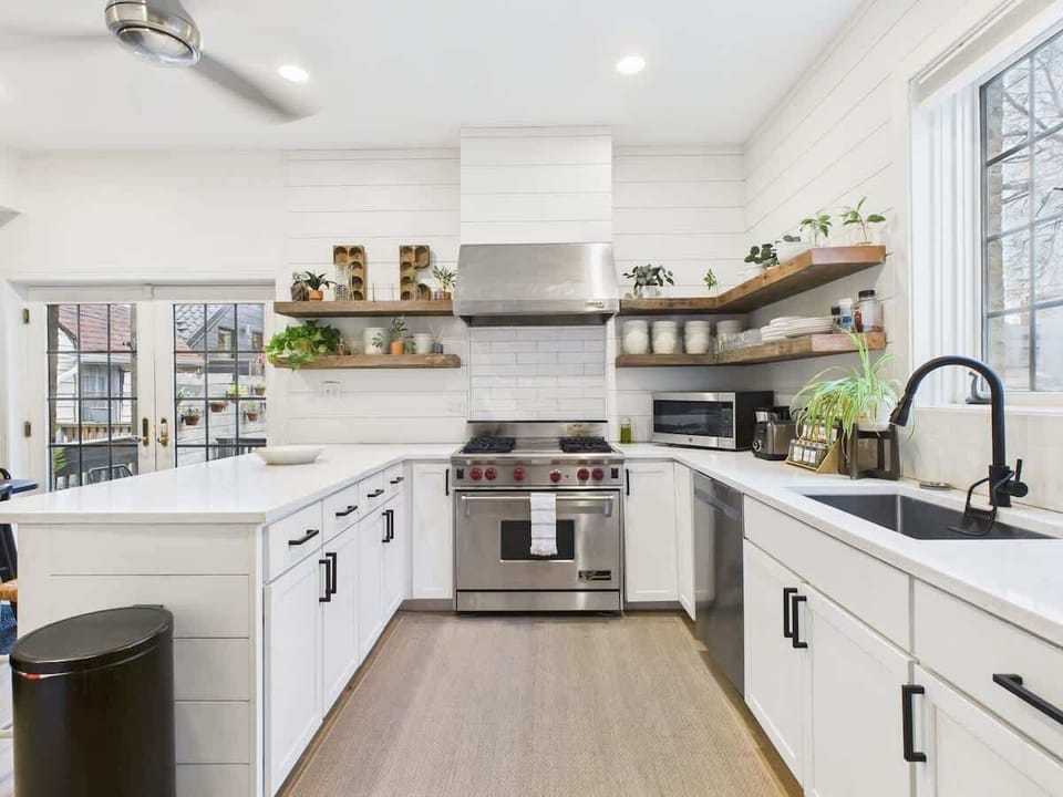 Open shelving, warm textures, and modern appliances create a space worth lingering in.