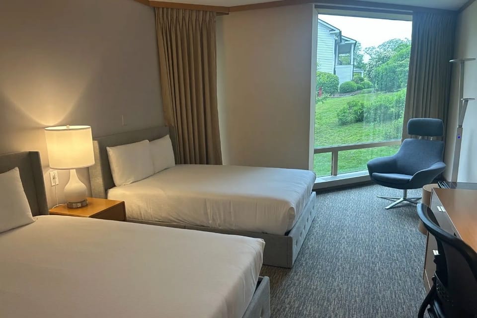 Step into the serene Croton Hall Double Guestroom, where modern furnishings meet scenic garden views, with easy access to trails, a fitness center, and a sauna.