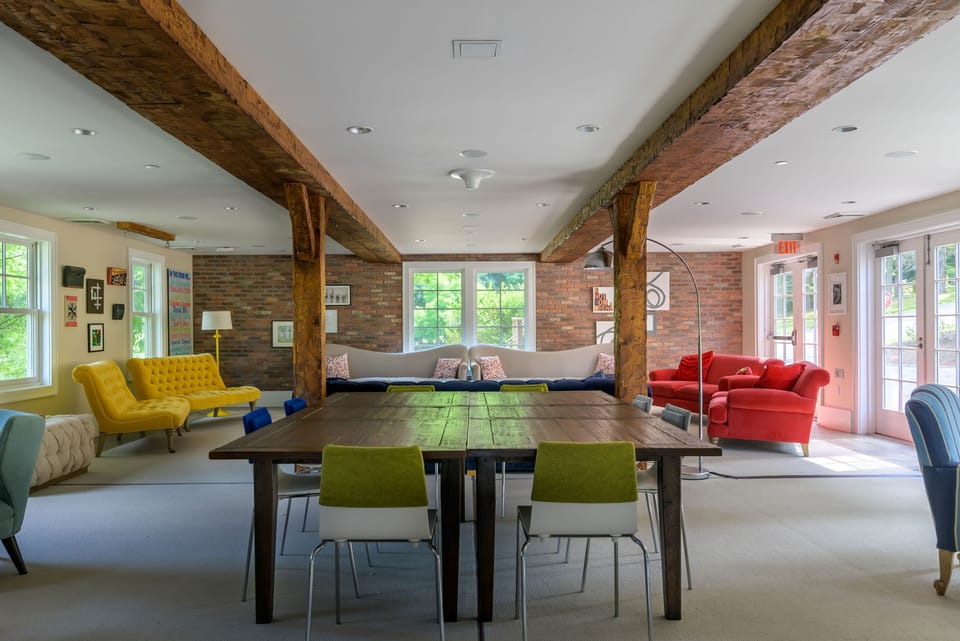 Warm tones and exposed beams set the stage for relaxed gatherings in this inviting  living in the barn.