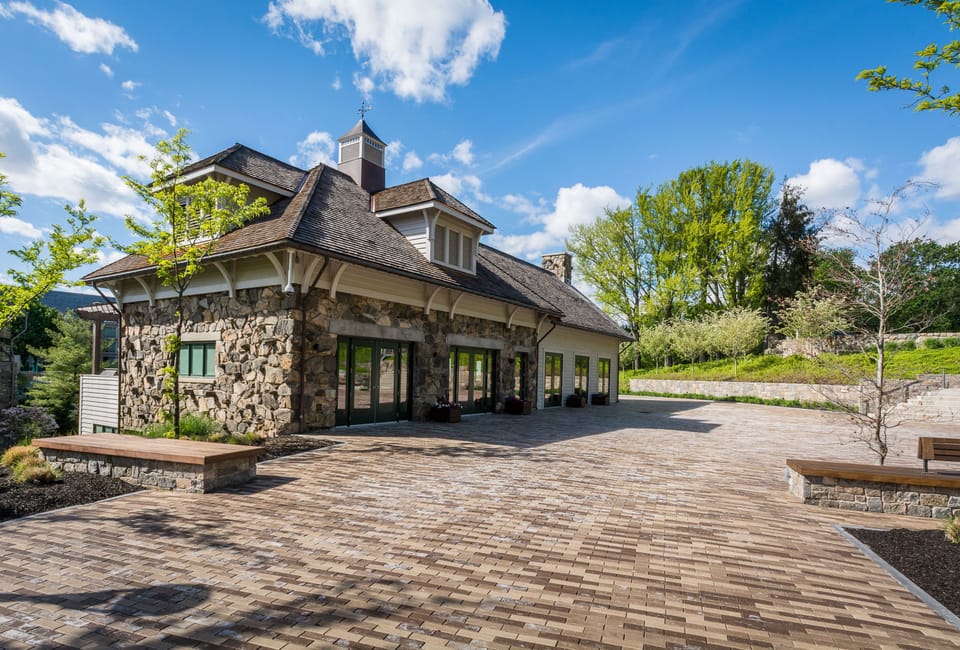 With its charming stone exterior and spacious patio, this picturesque building at Windrose on Hudson serves as a delightful venue for relaxation and social events.