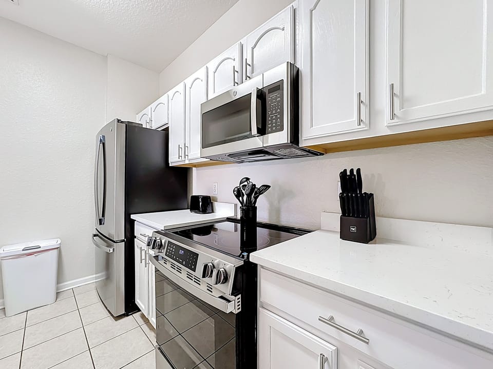 Kitchen includes many modern amenities, all stainless steel appliances, quartz 
