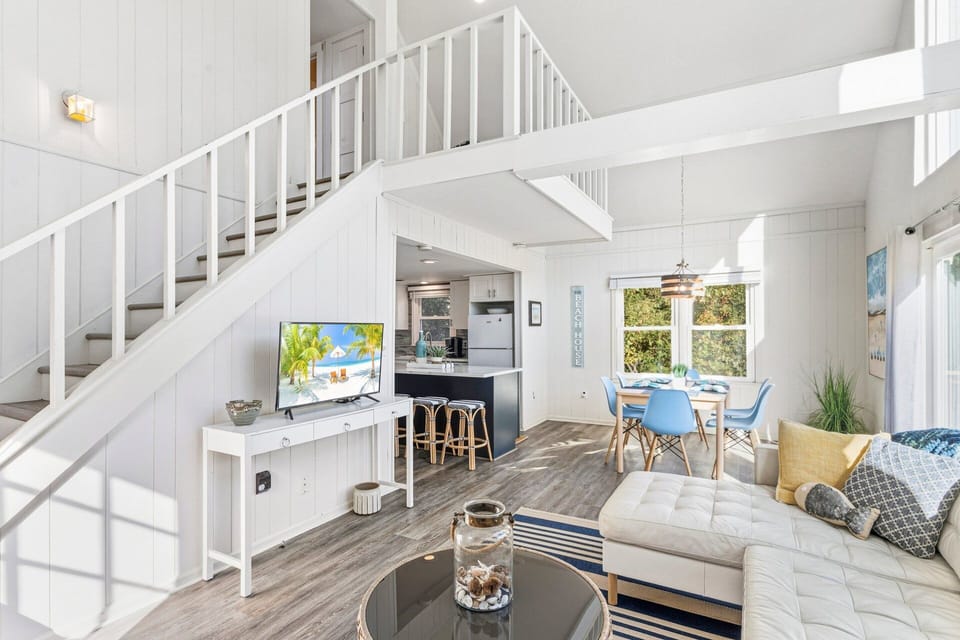 Gather with loved ones in the cozy, open-concept living area featuring plush seating and natural light streaming through large windows.