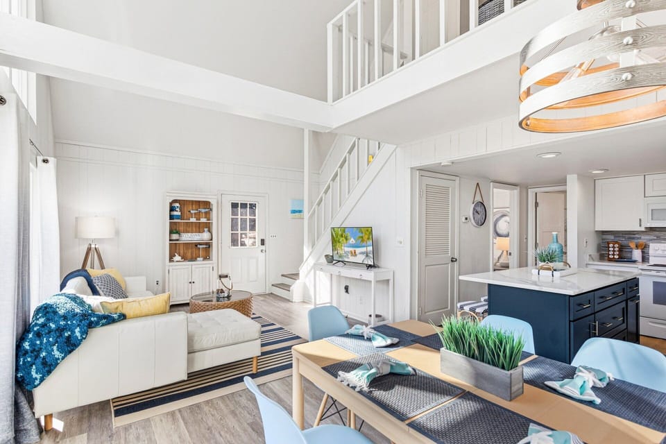 Gather with loved ones in the cozy, open-concept living area featuring plush seating and natural light streaming through large windows.
