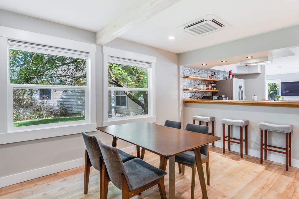 Dining room seating for 4 and bar seating for 3 in this open concept space | Interior