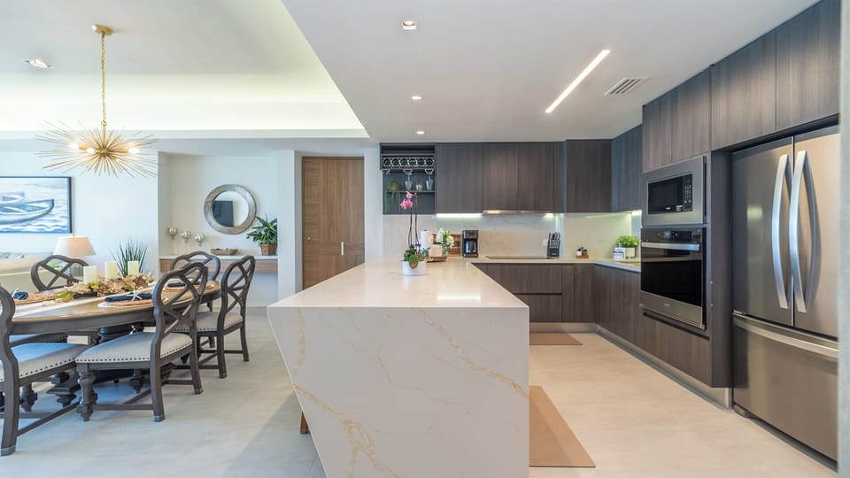 Modern and roomy, the kitchen features stainless steel appliances, inset wine rack, and a wine fridge as well