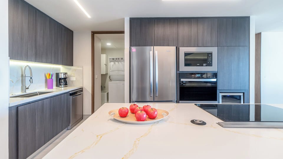 The kitchen and room with washer and dryer