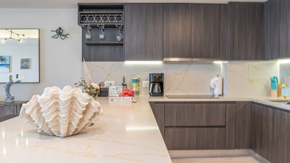 A long counter leads into the complete fully stocked kitchen