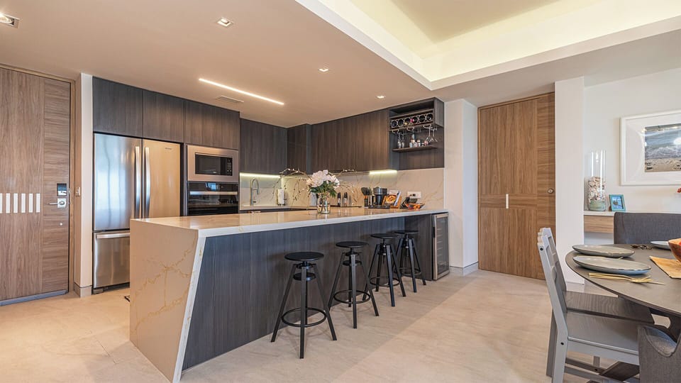 The grand kitchen island with bar stools.