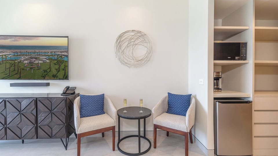 Small table for two and a functional kitchenette, perfect for casual meals or enjoying morning coffee while taking in ocean views.