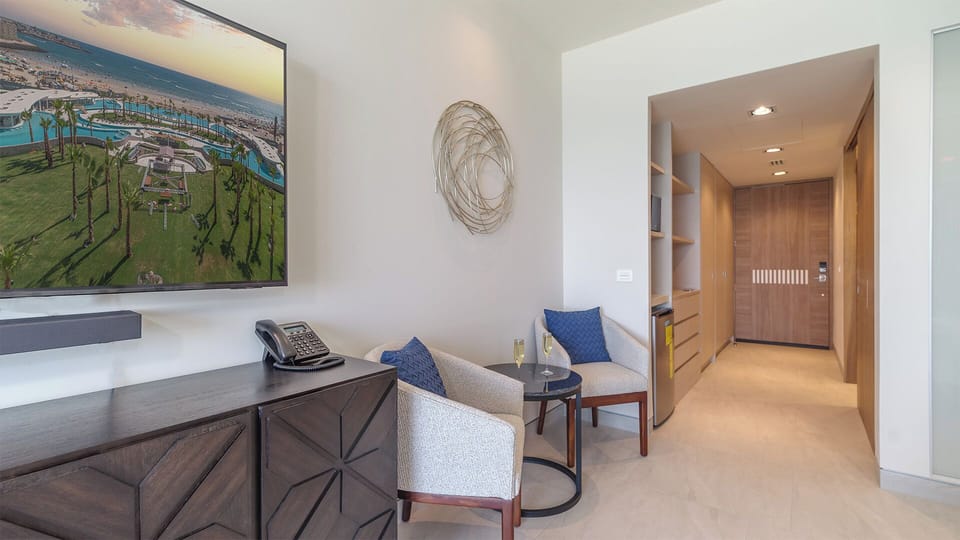 Room with TV, table, and chair for comfort and convenience.