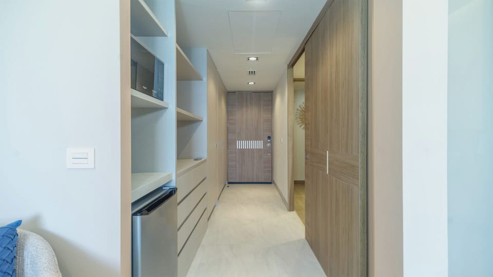 Bright kitchenette near the entryway, perfect for preparing coffee, light meals, or grabbing a snack as you come and go