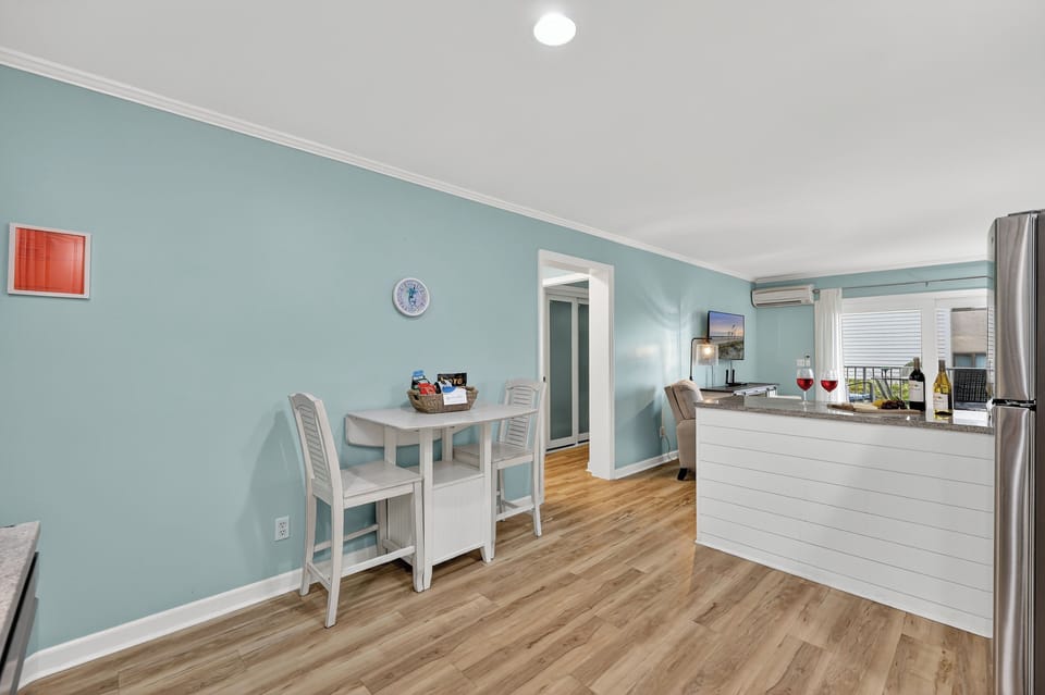Enjoy a lovely dinner at the dining area, overlooking the open floor plan of this villa