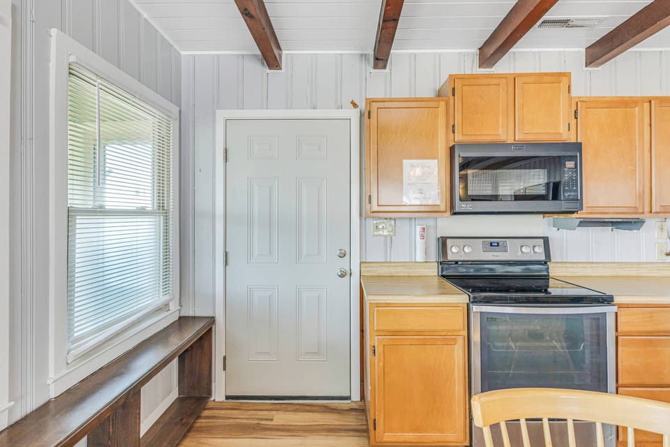Kitchen with complete appliances spacious countertops for easy meal preparation.