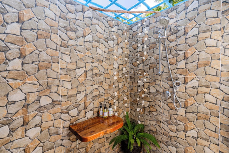 Beachfront Bure | Bathroom | Shower, towels, soap, shampoo