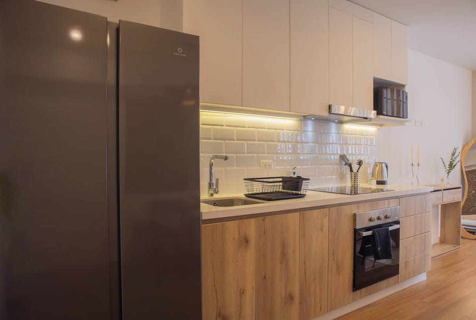 Full-sized refrigerator in kitchen.