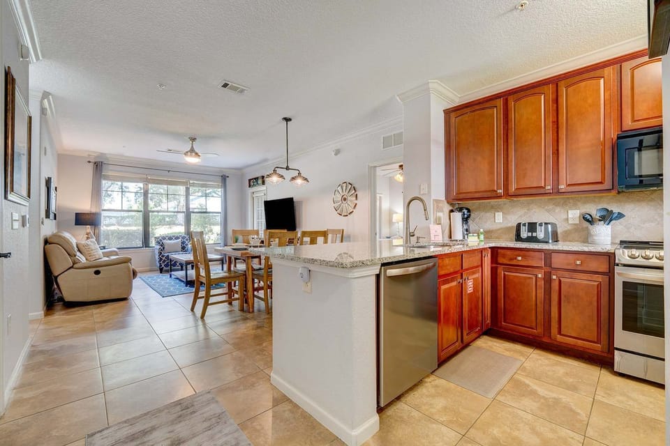 Open kitchen and dining area with natural light and warm wood cabinetry