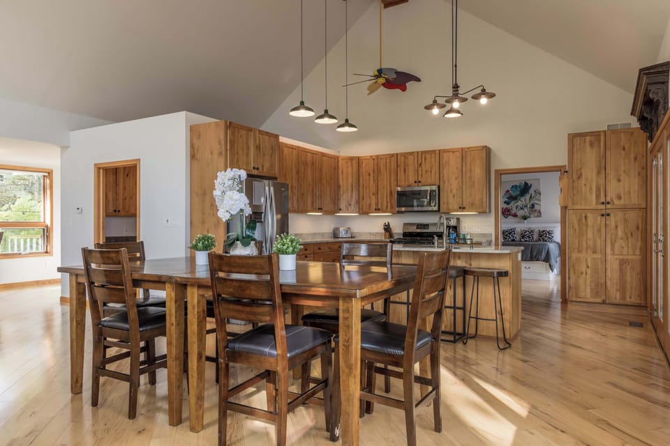 Kitchen open to the dining and living area, bright natural light and generous counter space built for group meals between Mackinac Island ferry runs
