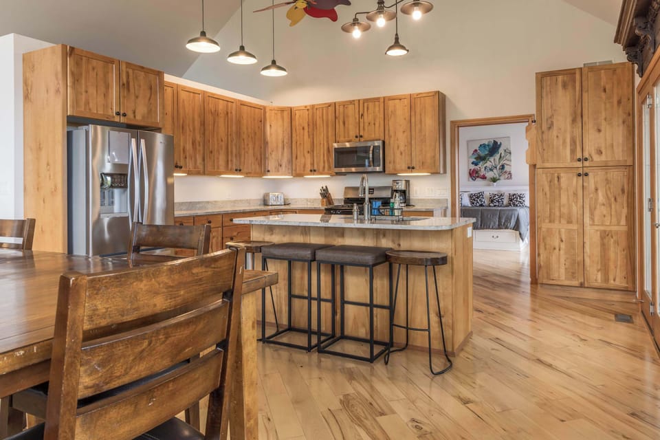 Kitchen sight line through to the dining area and beyond, open-concept layout keeps the whole group connected from cooking to conversation