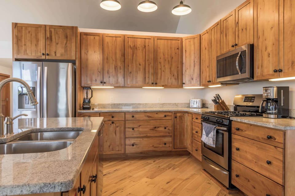 Fully equipped kitchen with stainless steel appliances and plenty of prep space, everything the group needs for home-cooked meals in St. Ignace
