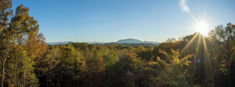 Sister Cabin Photo - Wake up to breathtaking views and the warm embrace of the morning sun. ☀️🌿 Enjoy your coffee as nature paints a masterpiece right outside your window—pure tranquility awaits!"