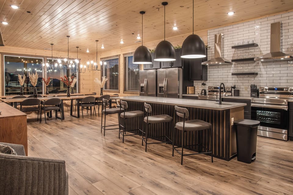 Sister Cabin Photo - Enjoy stylish countertop seating with a seamless flow to the dining area, offering an open view of the beautifully appointed kitchen.