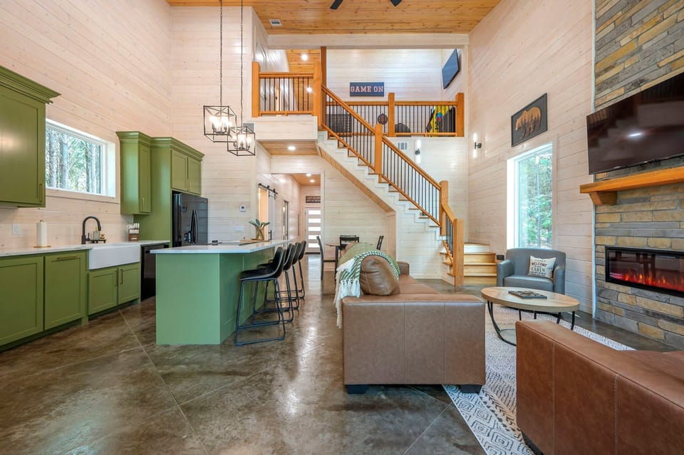 Bight open living area with Smart TV, electric fireplace, and leather seating