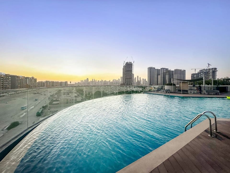 Infinity pool views: golden sunset over the stunning city skyline.