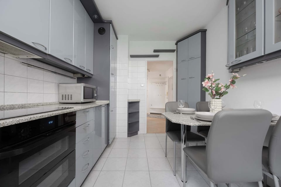 The kitchen with a long countertop and seating area encourages shared cooking and everyday chats over coffee.