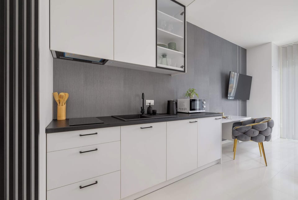 The sleek design of the kitchenette blending seamlessly with the living area.