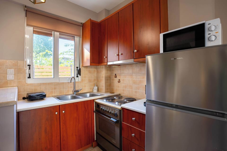 Fully Equipped Kitchen with Wooden Cabinets, Modern Appliances, and Ample Counter Space for Home Cooking
