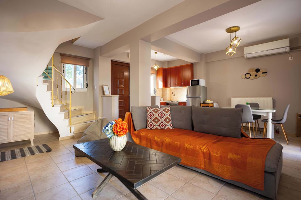 Bright Open-Plan Living Room Featuring Comfortable Sofa Seating, Neutral Tones, and a Welcoming Layout for Relaxing Indoors