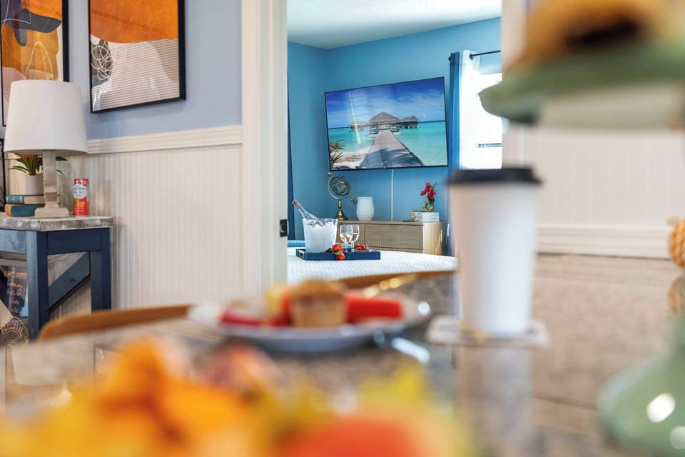 The primary bedroom, located just off the kitchen and dining area, offers both comfort and convenience.