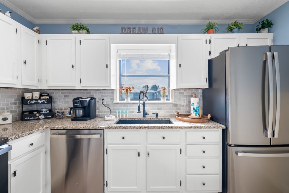 Kitchen: Outfitted with sleek stainless steel appliances and duel coffee maker for convenience.