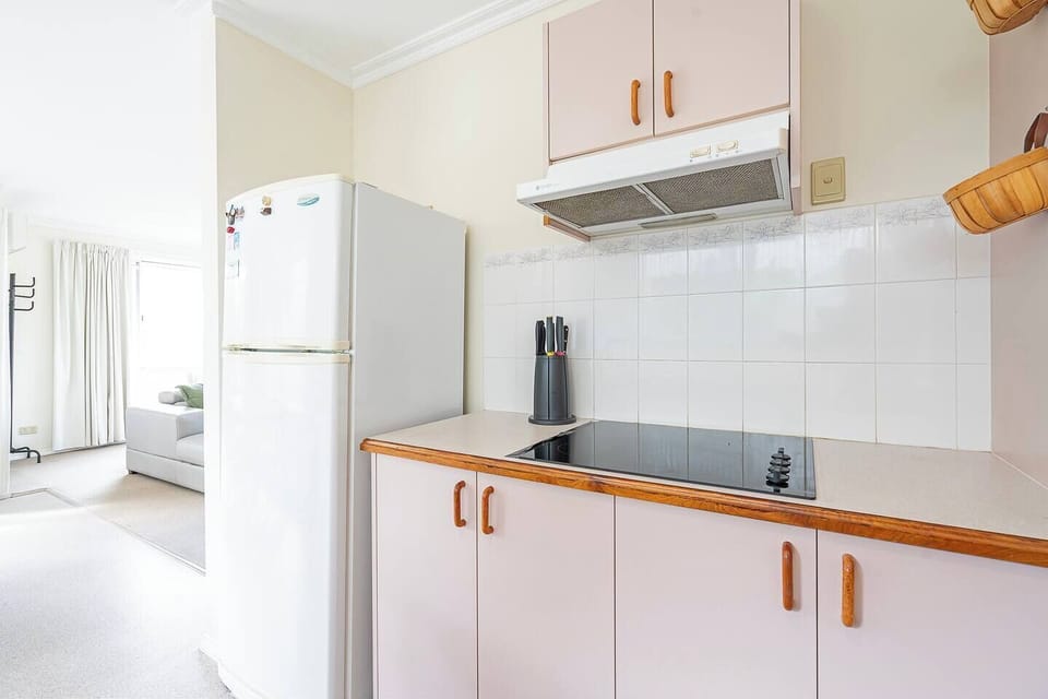 Cook with ease in a retro-inspired kitchen complete with stovetop, oven, microwave, rice maker, pour-over coffee, kettle, toaster, fridge, and all essential cookware.