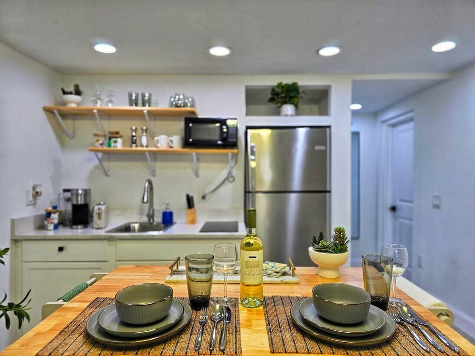 Welcome to our charming and fully equipped studio. This modern kitchen is perfect for preparing your favorite meals or a romantic dinner. It has a refrigerator, microwave, and all the cooking essentials you`ll need for a comfortable stay.