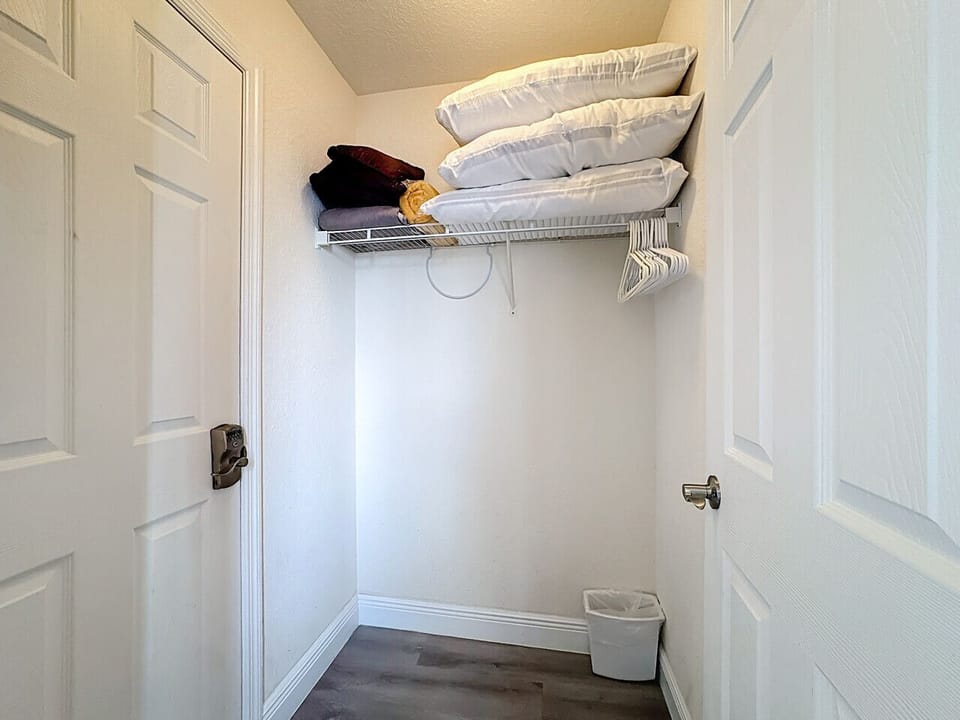 Convenient storage closet with shelving for your essentials.