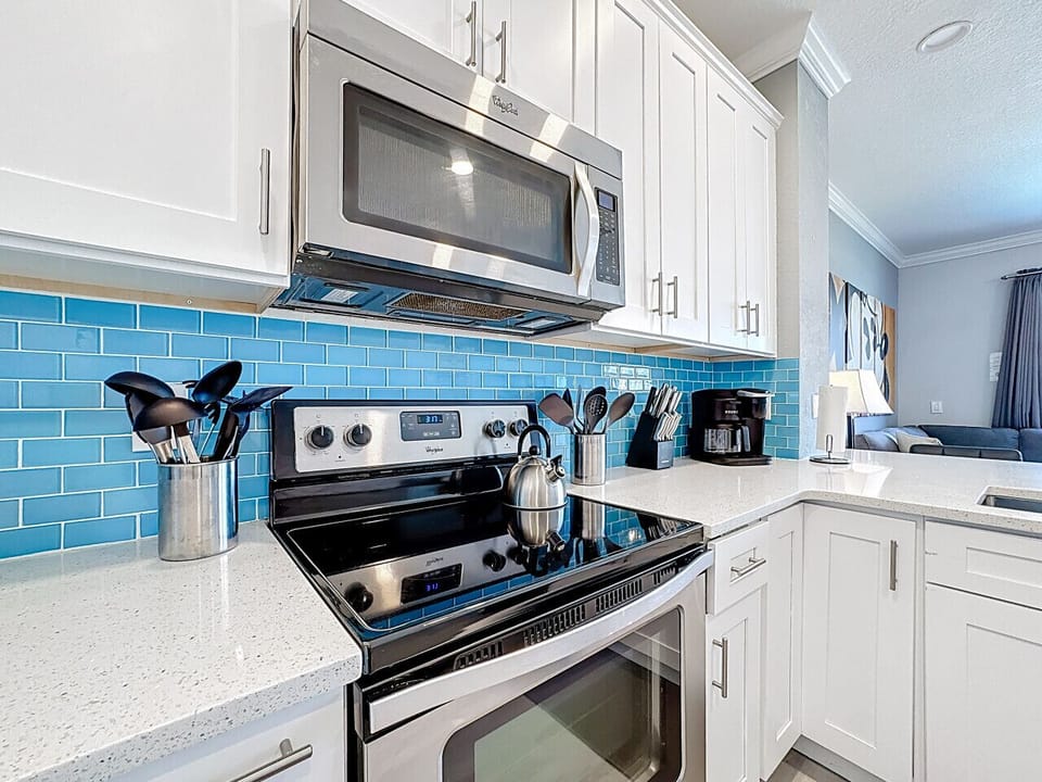 Modern kitchen with stove, microwave, and all cooking essentials.