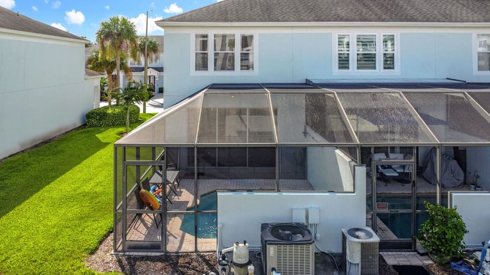 Exterior view of the screened-in pool and patio.