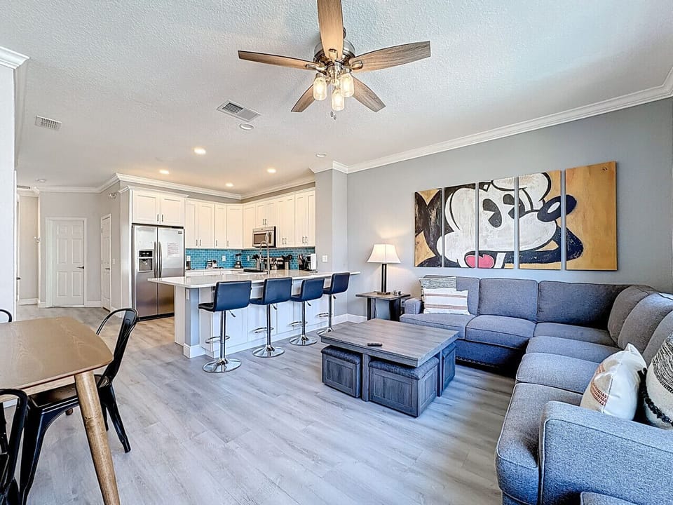 Modern open-concept kitchen and living room with plenty of seating and natural light.