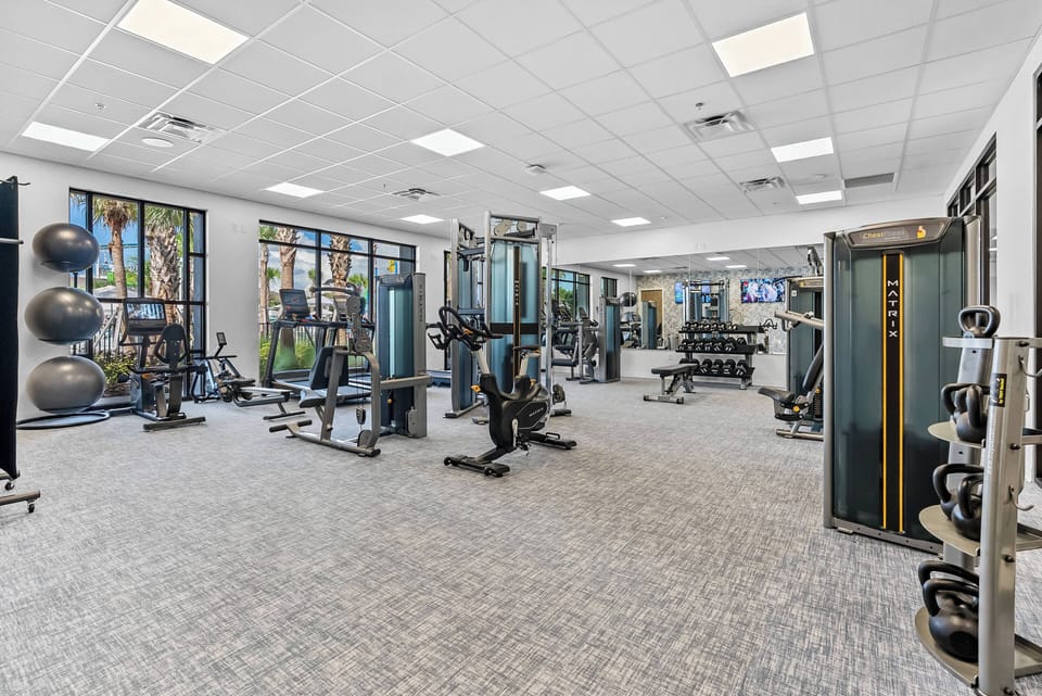 Our fitness center offers modern weight machines and free weights, all bathed in natural light from large windows. The sleek carpet adds comfort, ensuring your workouts are enjoyable and accessible.